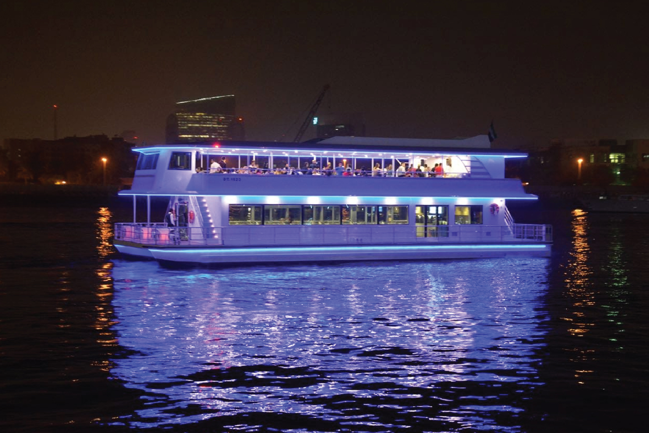 Luxury glass boat dinner cruise on Dubai Marina at night